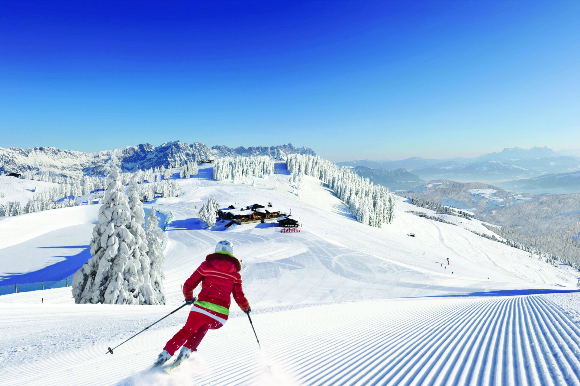 ski-in-red-outfit-on-a-groomed-ski-slope