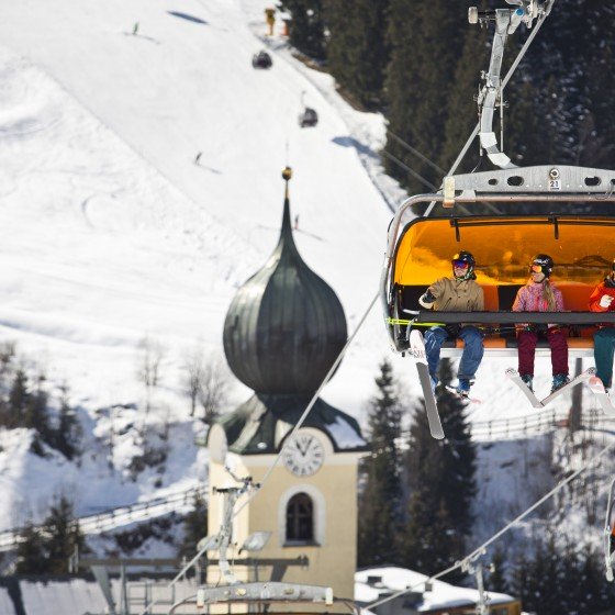 Saalbach - skiers on chair lift