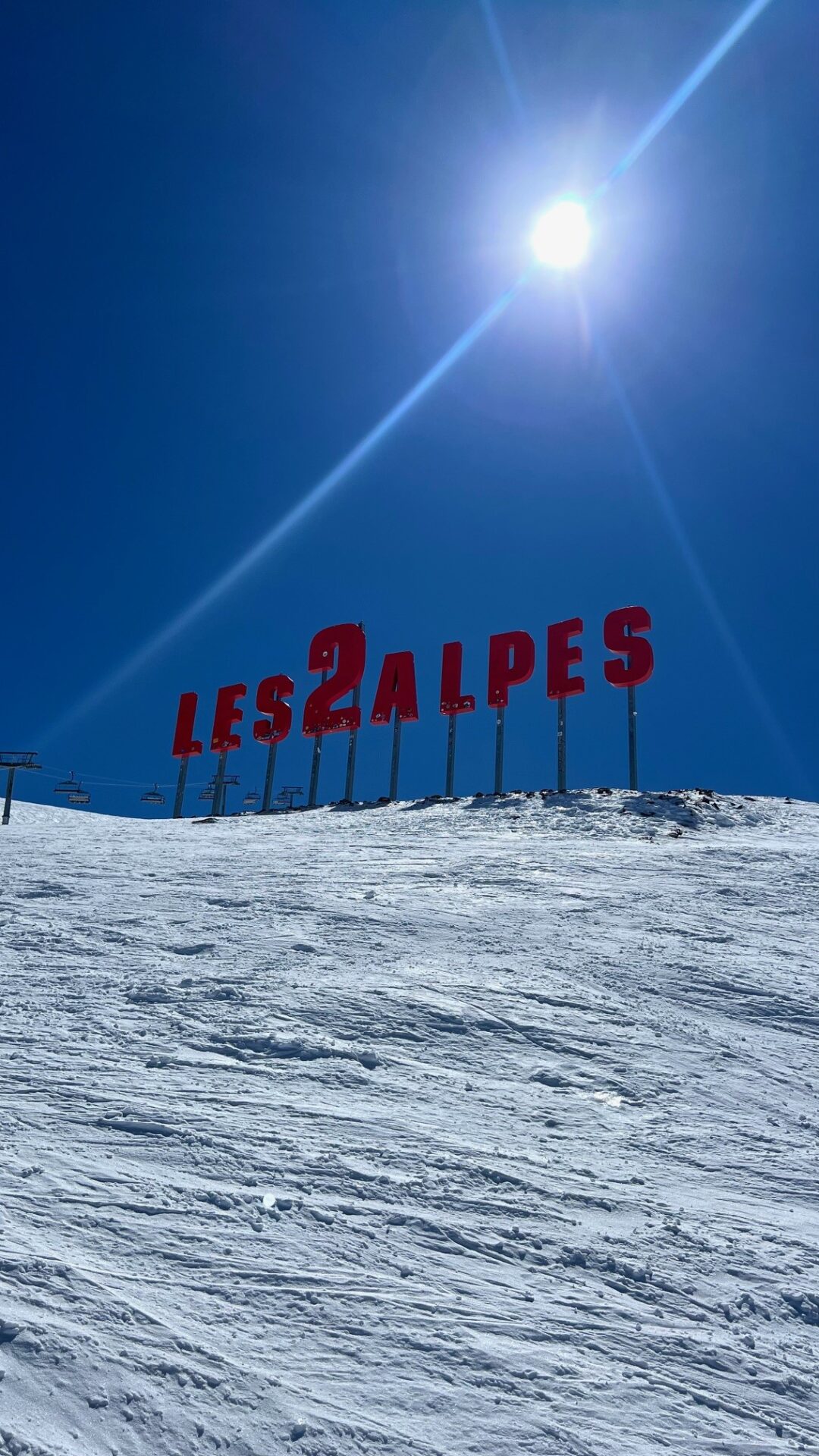 Les 2 Alpes letter sign planted in the snow