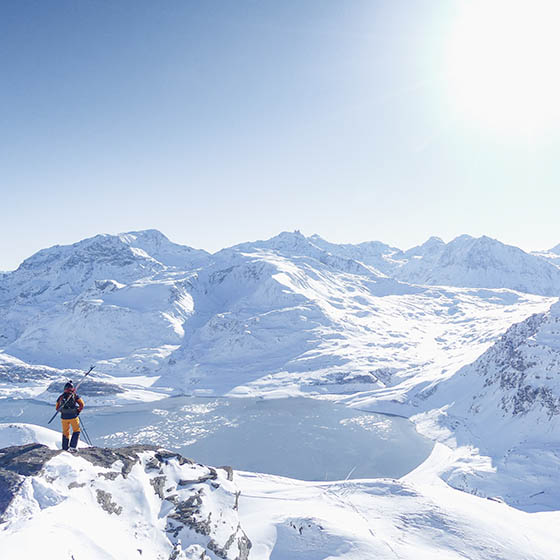 Man looking at the snoy mountains in Val Cenis