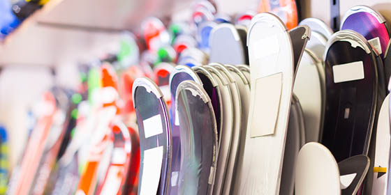 Large selection of skis in a store.
