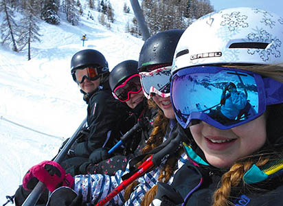 Happy students on ski lift