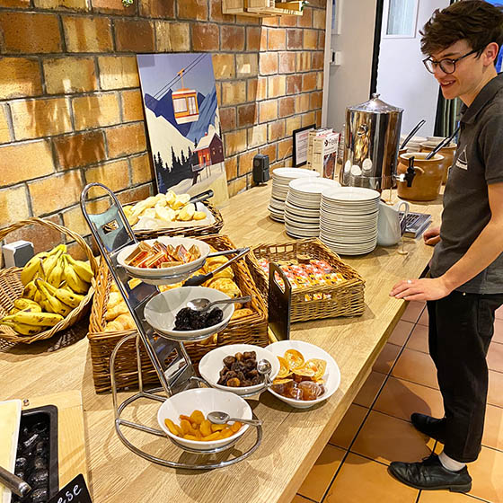 Buffet breakfast served with a smile at Clubhotel Vallée Blanche in Alpe d'Huez