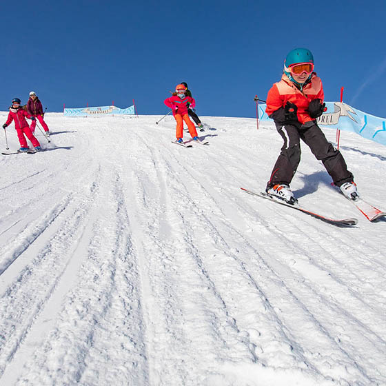 Students skiing down the slope