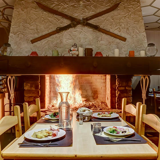 Cosy fireplace in the dining area of the Village Club Mileade in Valmorel