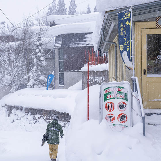 Skier walking to a shop in Hakuba