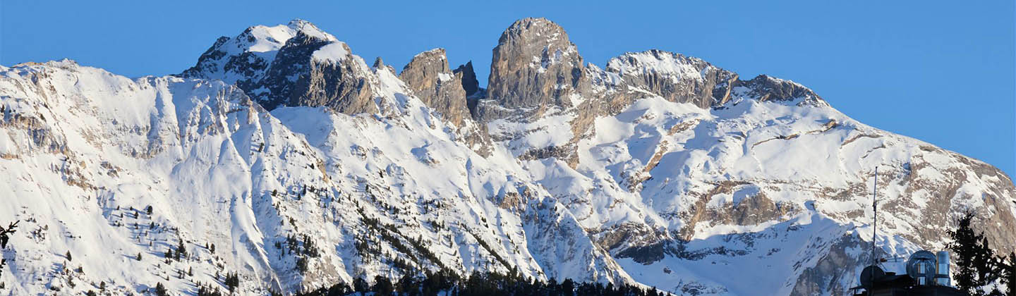Snowy peaks and a bright blue sky background in Courchevel, France