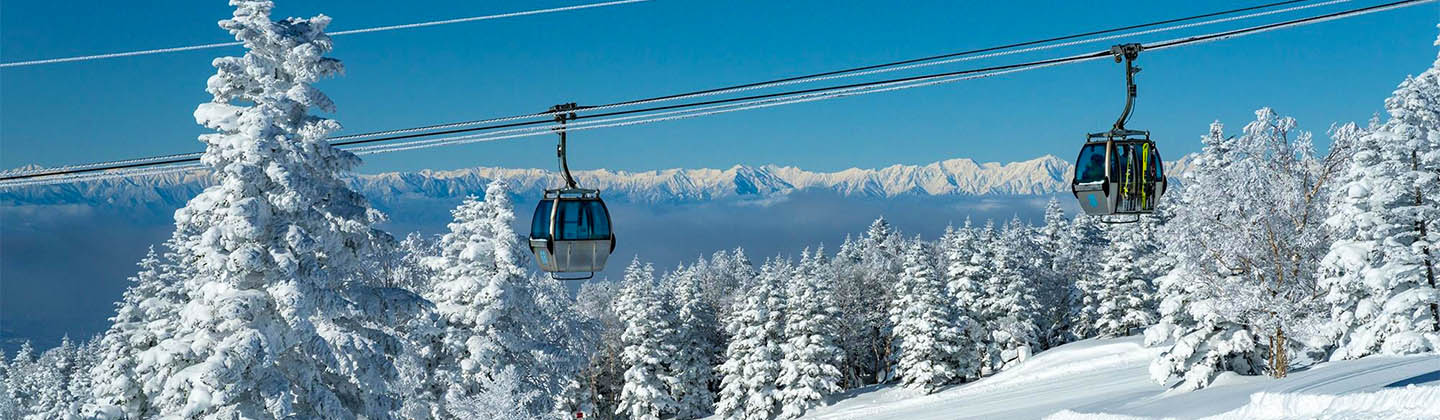 Cable cars and snow-capped mountains in Yakebitaiyama in Japan
