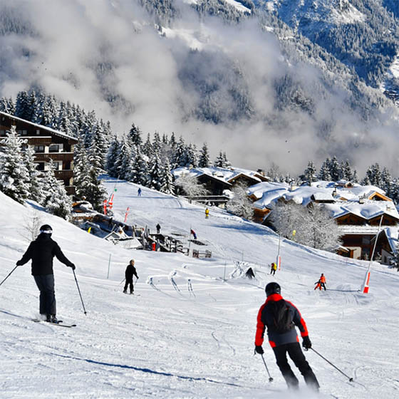 Skiers sliding down the slopes in Courchevel, France