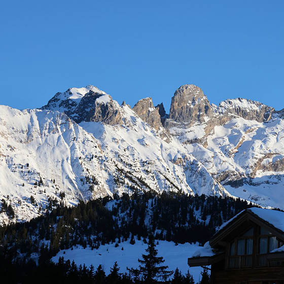 Snowy peaks and a bright blue sky background in Courchevel, France