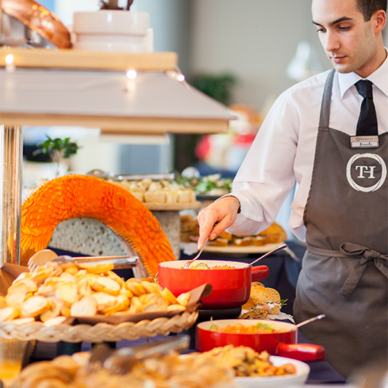Chef preparing food at the Olympic Village exterior in Sestriere