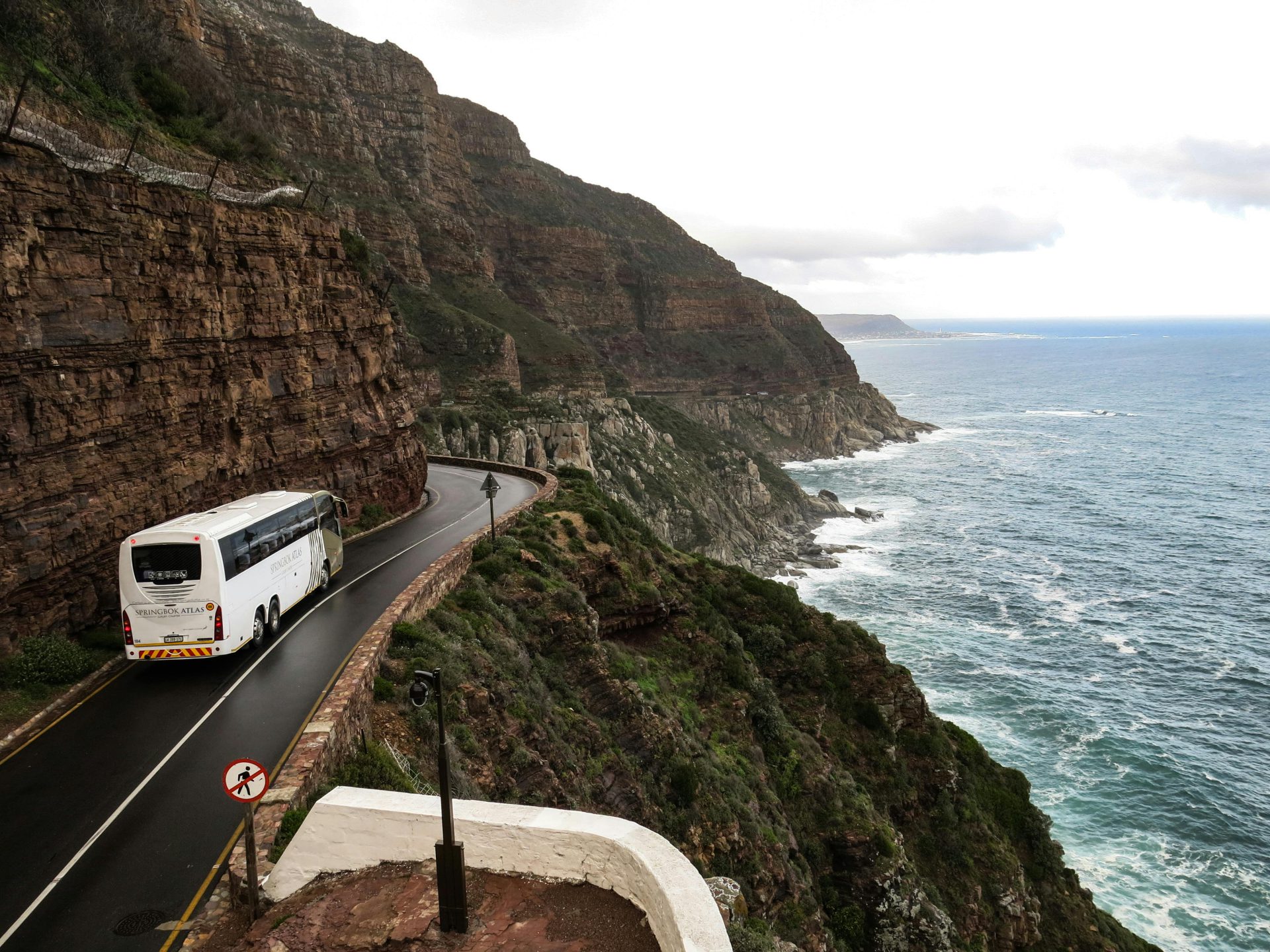 A coach driving along the coast