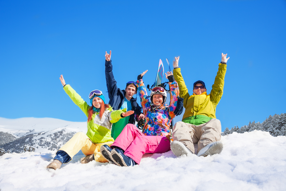 Group of snowboarders sitting on the snow
