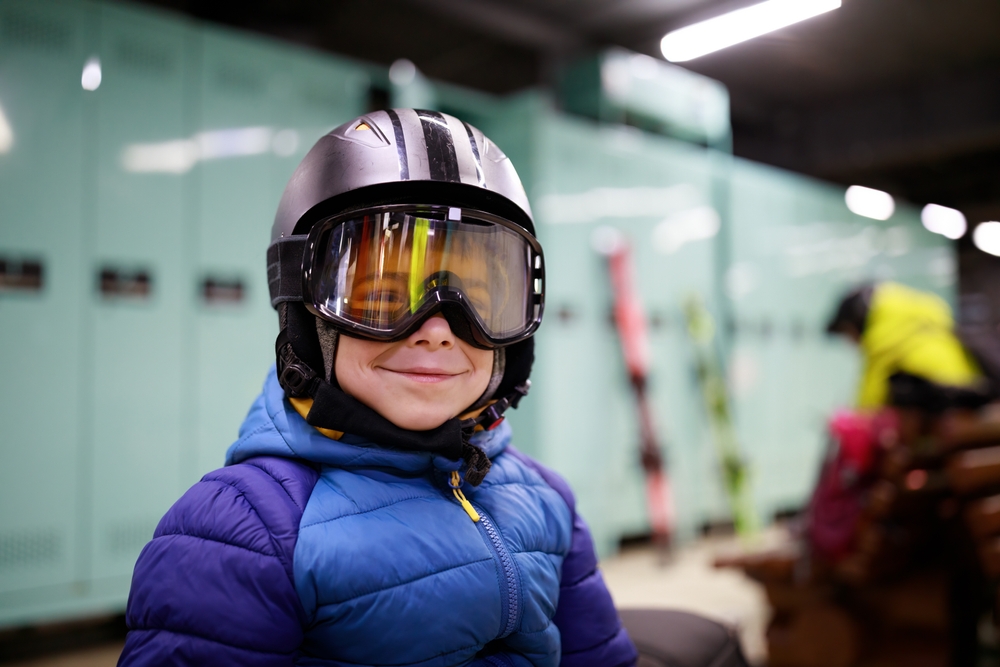 Smiling young skier getting ready