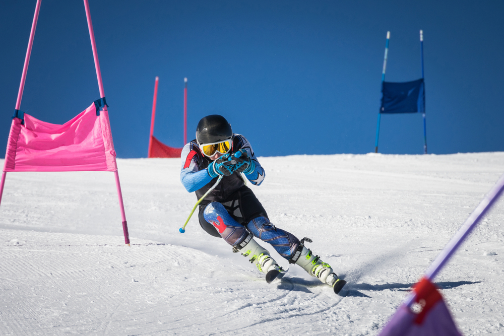 Young skier sliding down the piste in a slalom competition