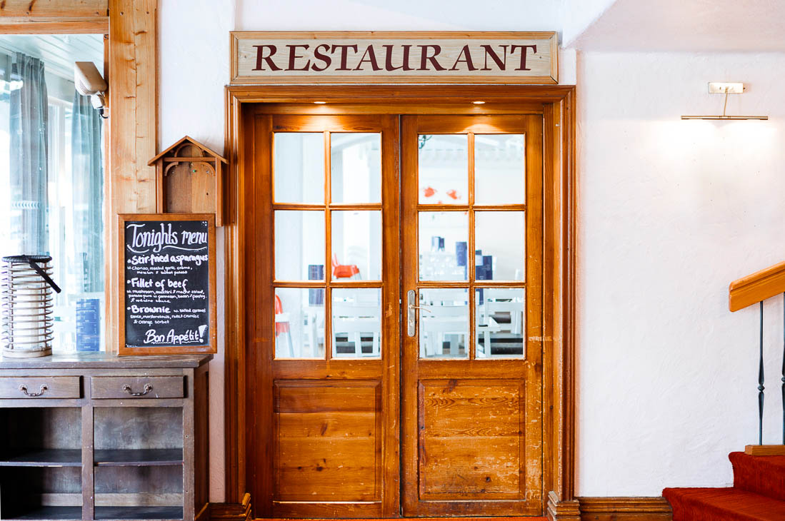 The wooden door restaurant entrance at Hotel La Brunerie, Les Deux Alpes