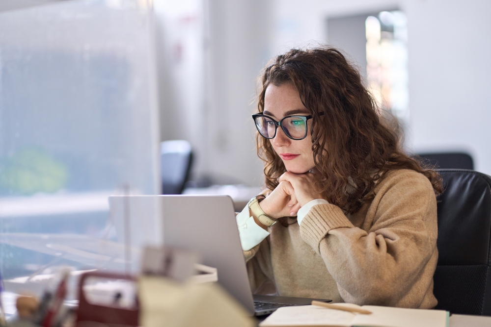 Teacher researching trip on her laptop