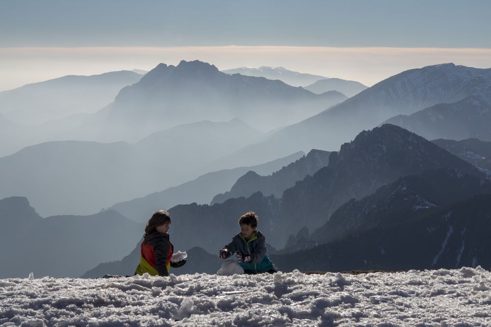 Children playing in the snow in La Molina resort, Spain